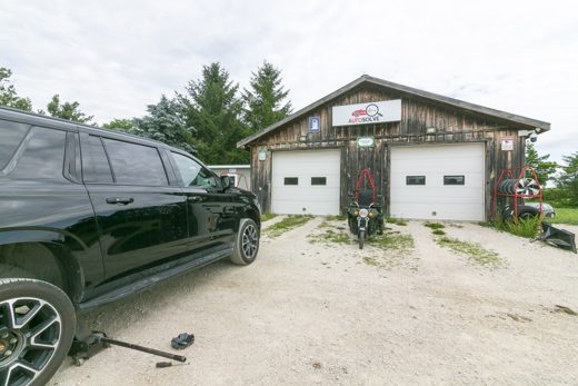 Auto Solve shop in Creemore with a customer's black SUV out front — your call, your vehicle, a local shop you can talk to directly
