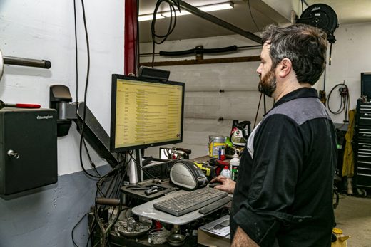 Technician writing up the inspection report at the workstation