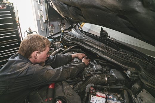 Auto Solve technician working through an engine repair to weigh the real cost of fixing versus replacing