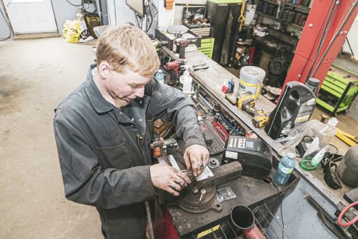 Auto Solve technician carrying out a hands-on repair at the bench vise without dealer markup