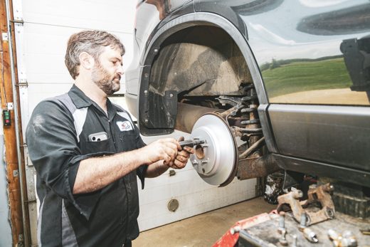 Auto Solve mechanic installing a new brake rotor and pads