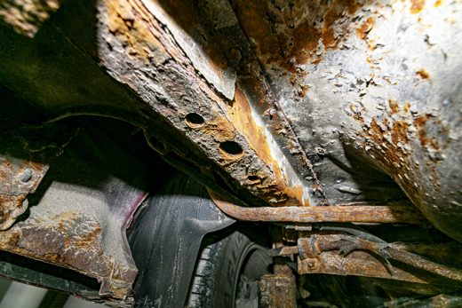 Severe rust and frame corrosion on a vehicle undercarriage — the damage rust does from the inside out