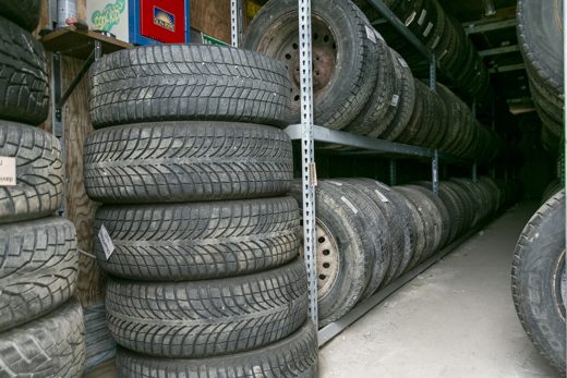 Racks of customer winter tires stored on shelves at Auto Solve