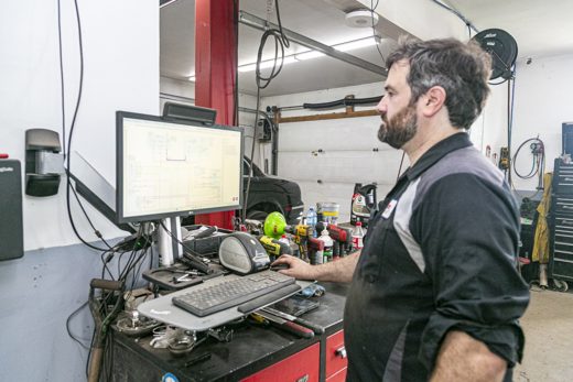 Technician reading a factory wiring diagram on the diagnostic computer at Auto Solve